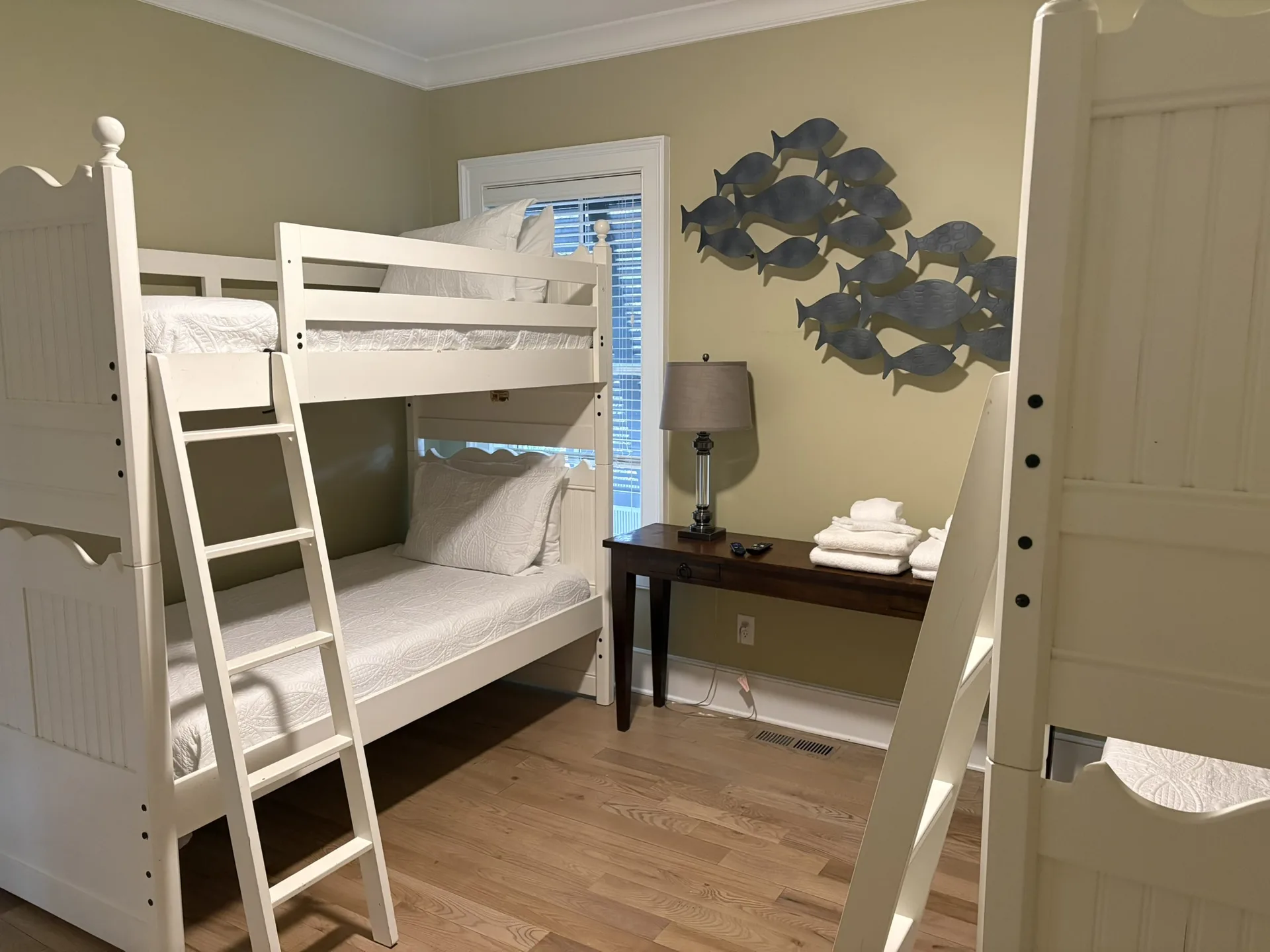 Guest bedroom with queen bed, white linens, and coastal gray walls