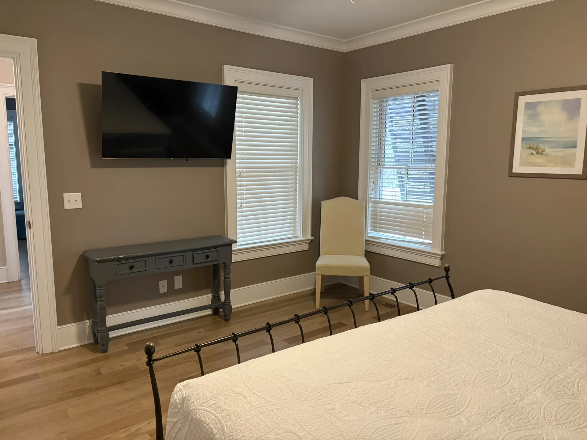 Second master with queen bed, large window, and coastal minimal decor
