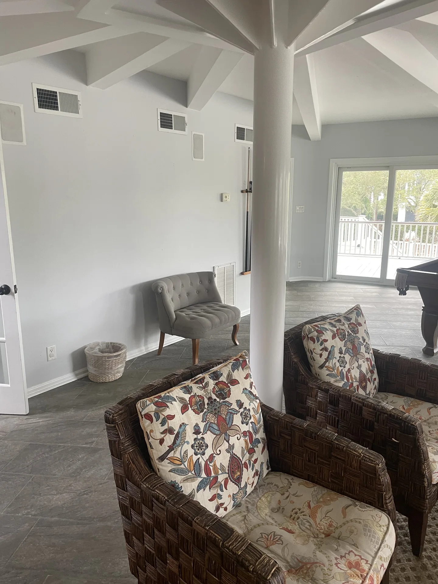 Open living area with vaulted beam ceiling and pool table in background